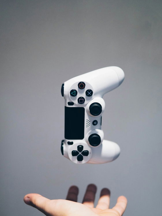 white Sony PS4 DualShock controller over person's palm
